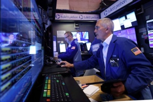 FILE PHOTO: Traders work on the trading floor at the New York Stock Exchange (NYSE) in New York City, U.S., April 4, 2024. REUTERS/Andrew Kelly/File Photo