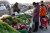 A woman looks at vegetables displayed at a stall at an outdoor market in Beijing, China January 12, 2024. REUTERS/Florence Lo